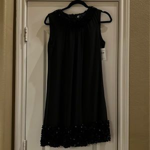 JSBoutique Sleeveless Size 6 Black A Line Dress with sequined neckline and hem.